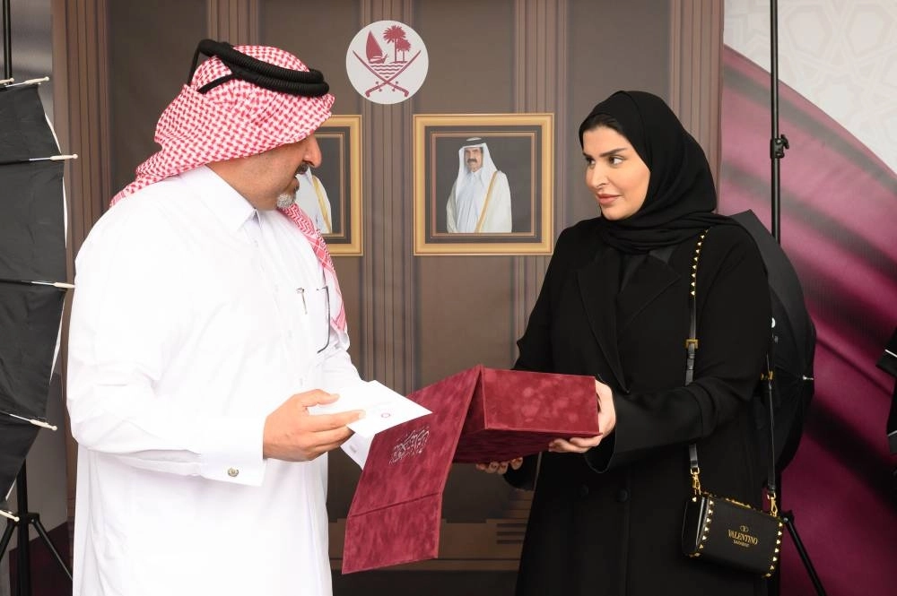 Her Excellency Ms. Maryam Bint Ali Al-Mesnad, Minister of Social Development and Family with a member in her tour of the exhibition, . 